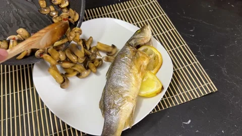 Serving of fish and mushrooms. Stock Footage 237869639