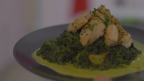 Serving a Fish dish with spinach Video stock 111967563