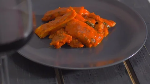 Serving fish dishes in a black plate. Fish in tomato sauce. Stock Footage 111966260
