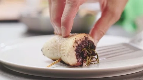 Serving fish roulade with olives on a plate. Stock Footage 157539891