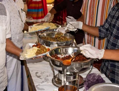 Serving food in buffet Stock Photos
