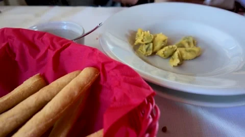 Serving Fresh Agnolotti Pasta on White Plate at Italian Restaurant Table Stock Footage 346345448