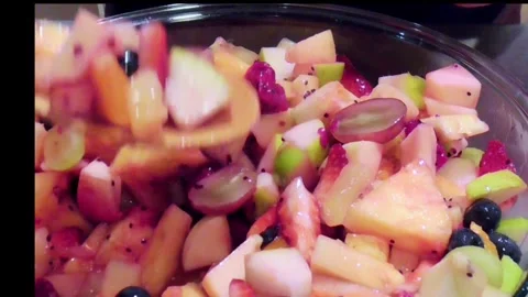 Serving Fresh Fruit Salad into Small Glass Bowl Stock Footage 345102338