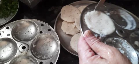Serving Fresh Idli from Steamer to Plate 動画素材 330056879