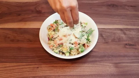 Serving Fresh Quinoa Salad with Parmesan, Pumpkin Seeds, &amp; Crispy Chickpeas Stock Footage 333790177
