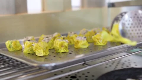 Serving Fresh Steamed Dim Sum Siu Mai Dumplings at a Buffet Stock Footage 334360495