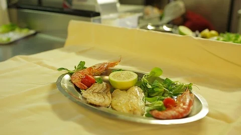 Serving freshly grilled fish in a plate Stock Footage 88439459