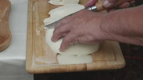 Serving freshly made and sliced traditional sheep cheese Stock Footage 314551921