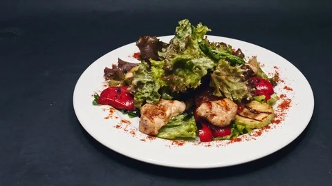 Serving fried chicken and lettuce salad with bell pepper and sauce in 4k Stock Footage 99224361