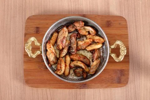 Serving fried chicken in high-angle copper bowl on wooden table Stock Photos