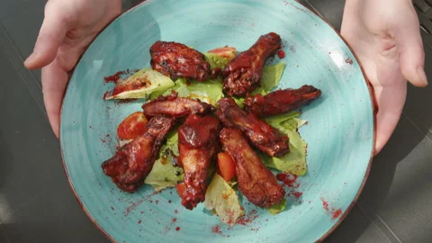 Serving fried chicken wings buffalo in chili barbecue sauce at restaurant Stock Footage 220710228