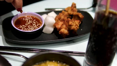 Serving fried chicken wings buffalo in chili barbecue sauce at restaurant Stock Footage 302090864