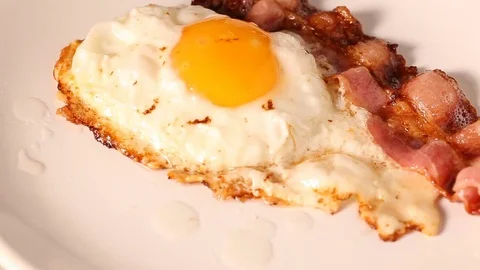 Serving fried egg with bacon Stock Footage 82745019