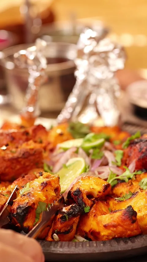 Serving Grilled Chicken Tikka and Tandoori Meat at a Restaurant Stock Footage 337875447