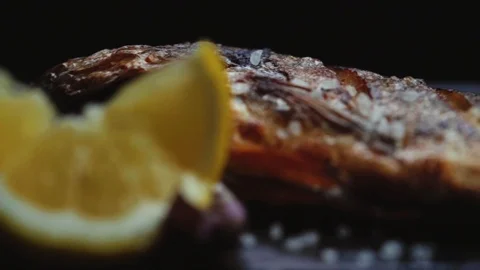 Serving grilled fish on a black background Stock Footage 121723028