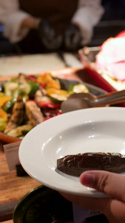 Serving Grilled Vegetables and Roast Ham at a Buffet Dinner Stock Footage 335118402