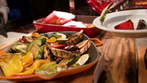 Serving Grilled Vegetables with Tongs at a Buffet Station Stock Footage 335850480