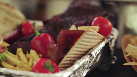 Serving of hamburger with fresh fries and salad Stock Footage 115731270
