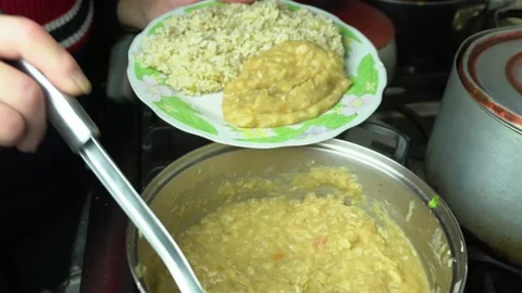 Serving homemade Lima Bean stew on a dish with rice Stock Footage 139831152