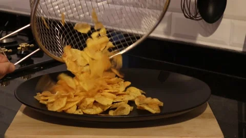 Serving Homemade Potato Chips on a Black Plate Stock Footage 148683835