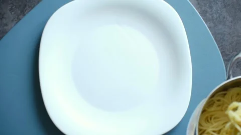 Serving hot cooked spaghetti pasta on a white plate Stock Footage 337891730