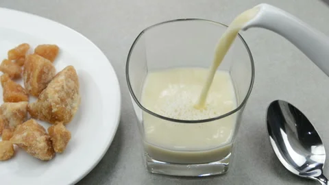Serving hot jaggery milk Stock Footage 140281650