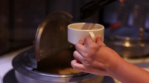Serving Hot Noodle Soup at Buffet Self-Serve Station Stock Footage 323683064