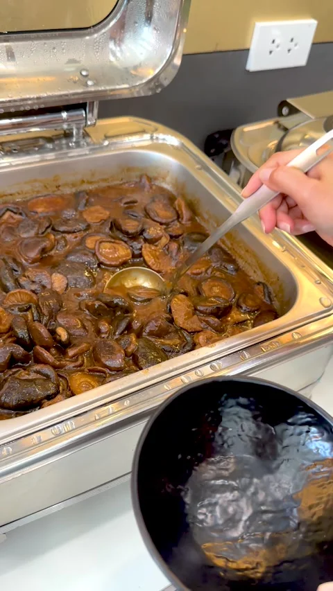 Serving Hot Shiitake Mushroom Stew from a Buffet Chafing Dish Stock Footage 334314164
