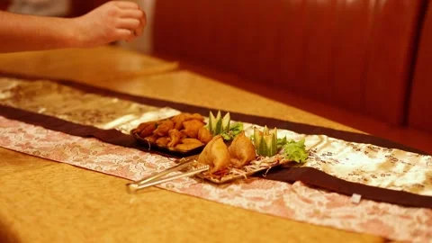 Serving Indian Appetizers Samosa and Pakora with Tongs on Table Stock Footage 342588642