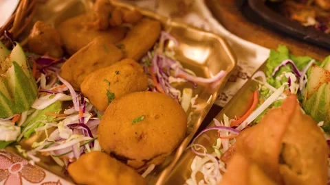 Serving Indian Appetizers with Tongs at a Restaurant Dinner Stock Footage 343599992