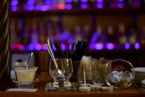 Serving items against the background of purple shop window lights. Stock Photos