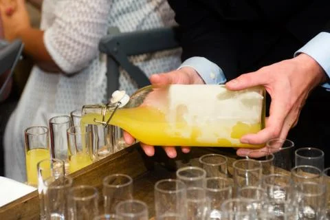 Serving limoncello in glasses Stock Photos