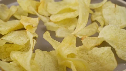 Serving many homemade circular potato chips on a gray ceramic plate Stock Footage 280089881