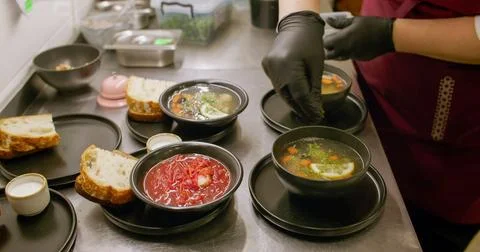 Serving meal kitchen process greens hot soup chef Stock Photos