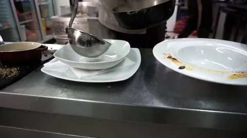 Serving minestrone soup with vegetables in the white bowl. Slow motion Stockbeeldmateriaal 72438492
