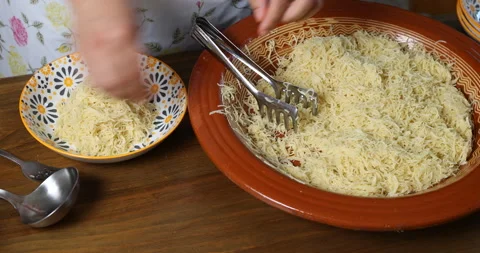 Serving Moroccan Seffa vermicelli into a small bowl Stock Footage 340230198