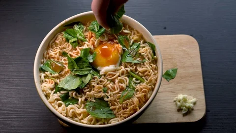 Serving Noodle Soup on Tray in Restaurant and Adding Seasoning Stock Footage 105847610