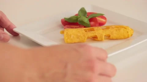 Serving omelette in a white plate Stock Footage 133814493