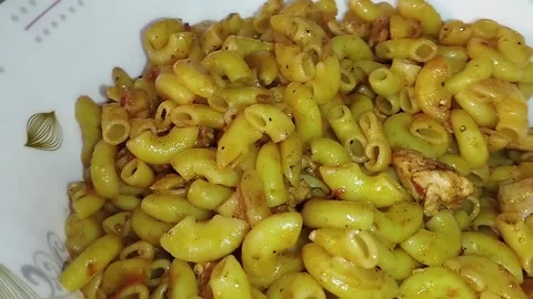 Serving of Pakistani-style Chicken Masala Macaroni, a popular desi fusion di Stock Footage 329735629