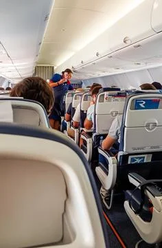 Serving passengers on the plane. Stock Photos
