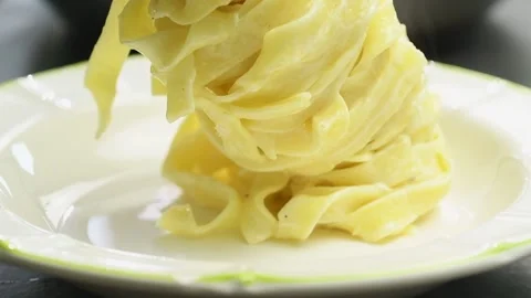 Serving pasta on a plate, slow motion. Stock Footage 165615507