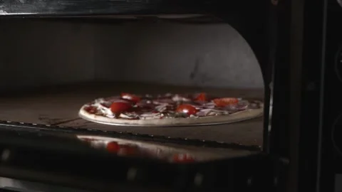 Serving pizza from the oven with smoke Stock Footage 154987860