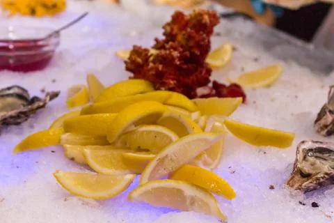 Serving place with ice, lemons, shells and oyster sauce 写真素材