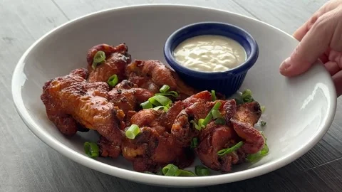 Serving a Plate of Buffalo Chicken Wings Stock Footage 316909006