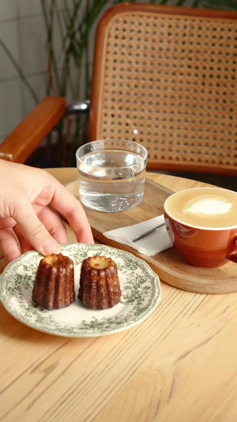 Serving Plate of Caneles with Coffee at Cafe Table Stock Footage 343762338