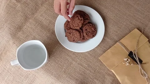 Serving a plate of chocolate biscuits for the guest  Stock Footage 150398925