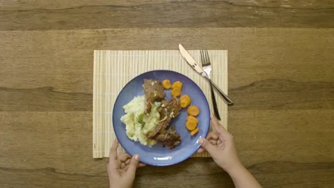 Serving a plate of lamb ribs with potato, garlic, lemon and spices Stock Footage 135360429