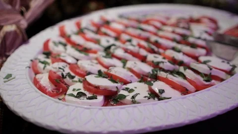 Serving plate of mozzarella tomato and basil Stock Footage 96178124