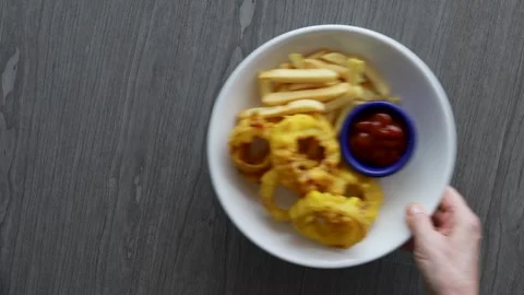 Serving a Plate of Onion Rings and French Fries Stock Footage 313144648
