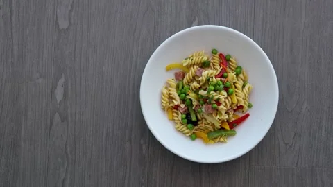 Serving a Plate of Pasta Salad with Vegetables Vidéo 313144640